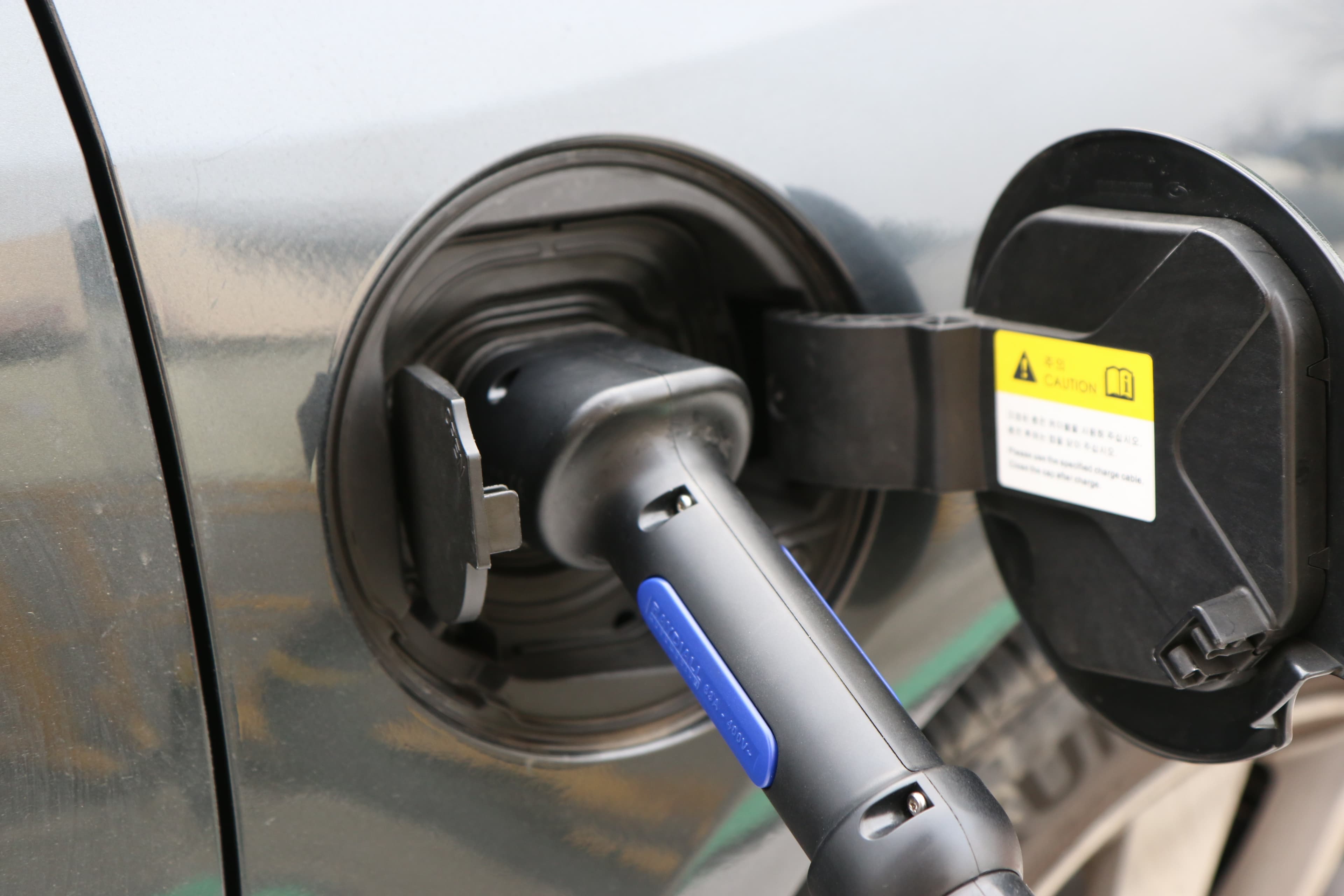 Multiple electric vehicles charging simultaneously at public charging bays