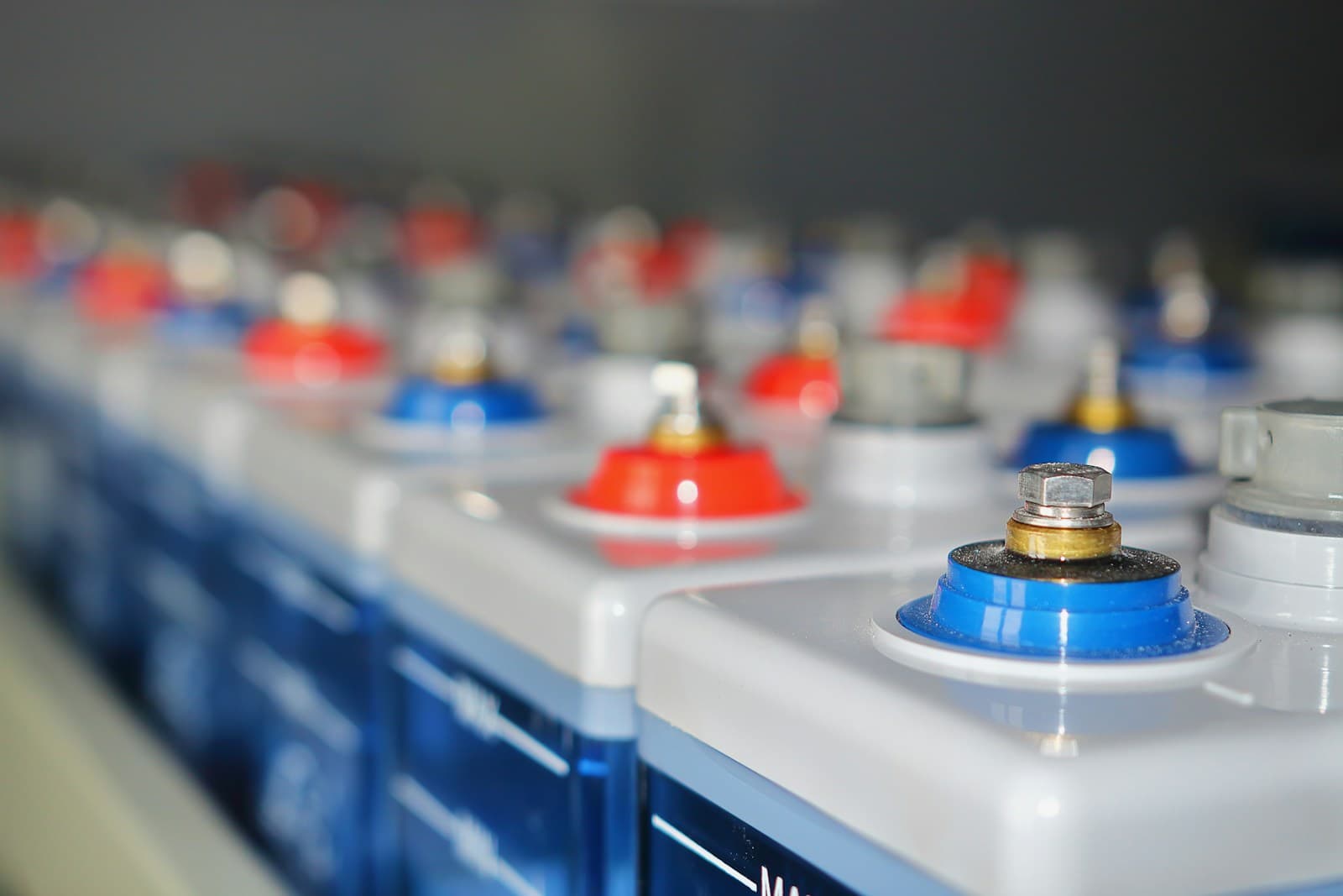 Rows of industrial OPzV lead-acid batteries in a commercial installation