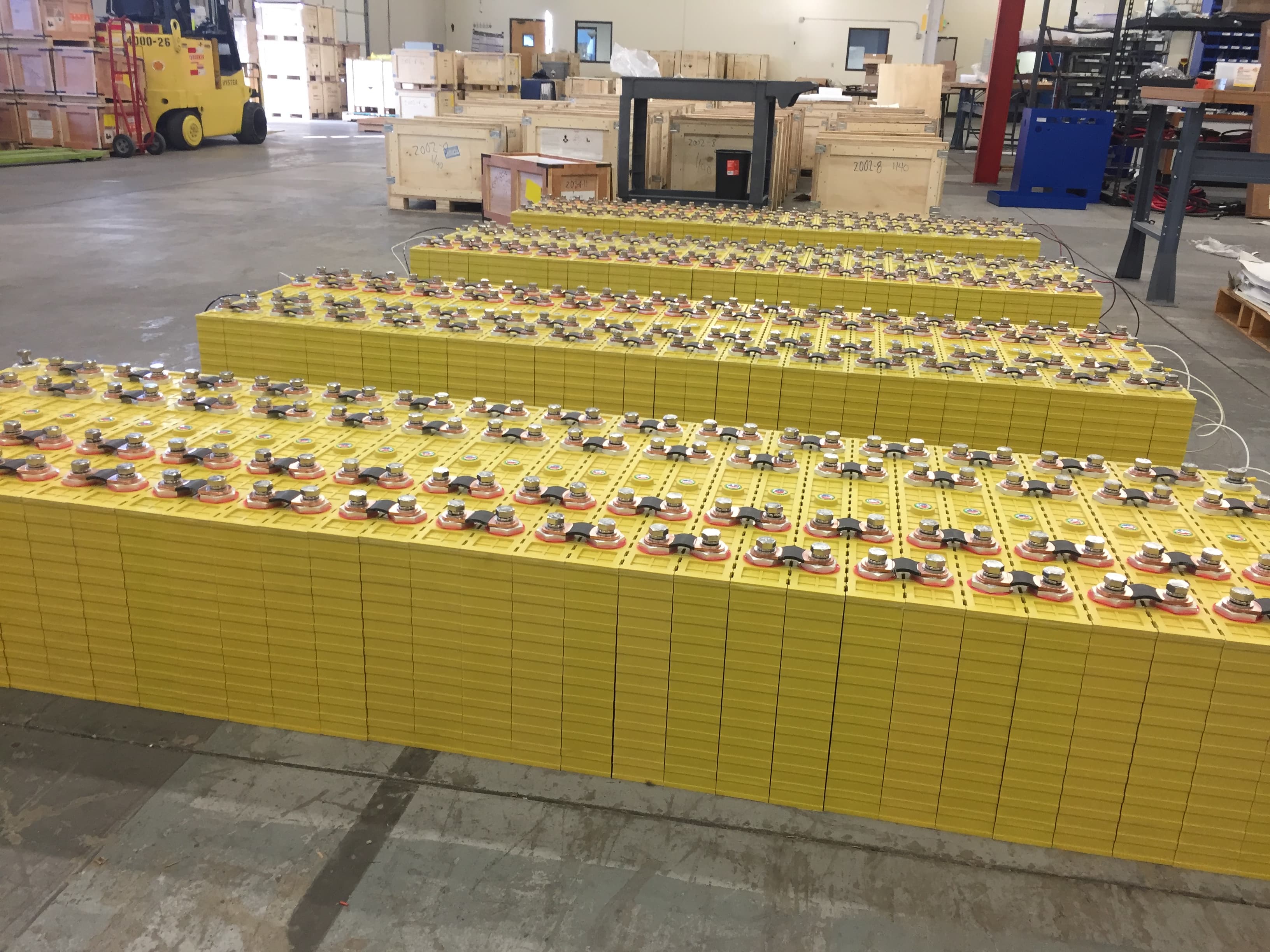 Rows of 700Ah LiFePO4 prismatic cells laid out for balancing before battery assembly